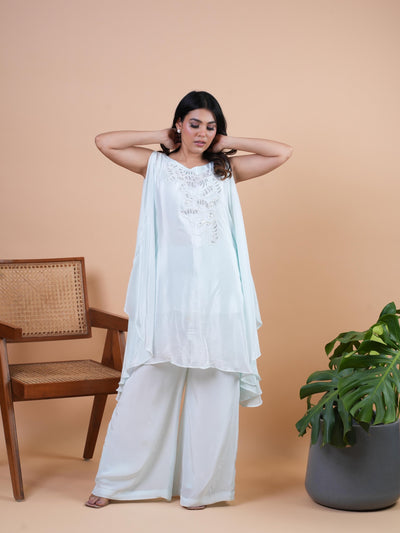 Our AROHA kaftan set with the open slit sleeves and delicate handwork with cutdana n pearls. Its premium Italian crepe outfit. Complete with a bottom sharara.