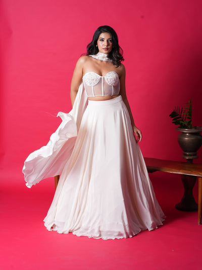 JULIE-The Corset Crop top features stunning handwork on the top, while the skirt and dupatta add an elegant touch. Made with premium Italian Crepe, it's available in four gorgeous colors.